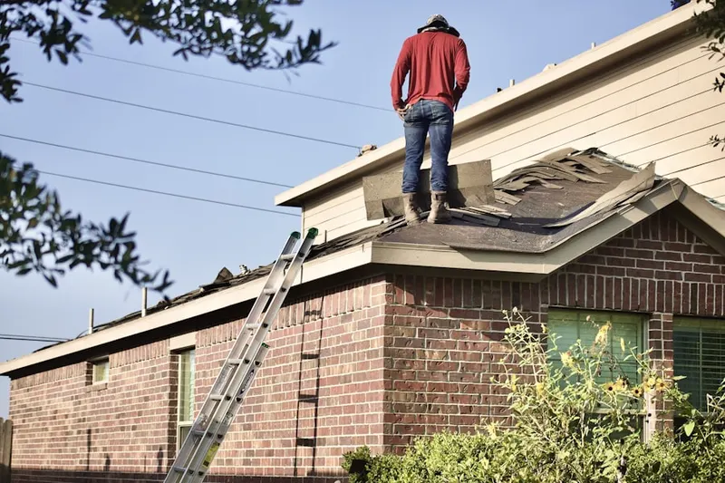 Professional roofer working on a residential roof in Waite Park